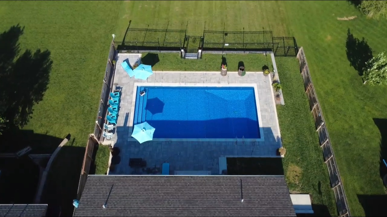 Backyard pool with slide covered patio and fire pit area
