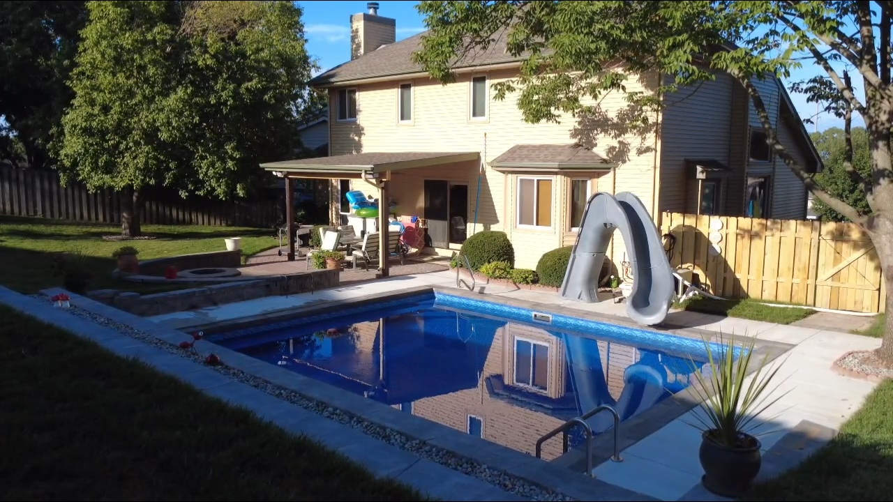 Custom boulder waterfall with integrated pool slide and stone steps