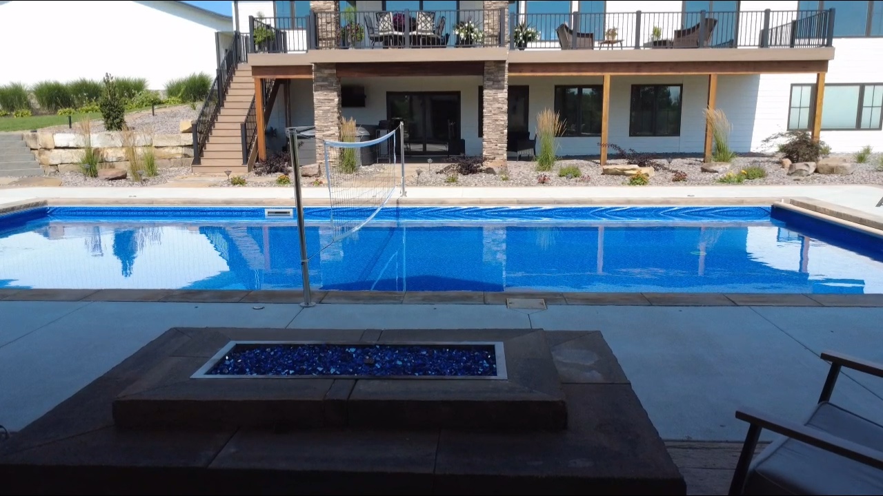 Natural boulder waterfall feature with cascading water into pool